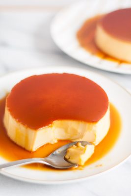 The Ultimate Creme Caramel (Leche Flan) Recipe - a perfect balance of a sweet egg custard with a slight punch of lemon. It’s definitely rich, smooth, and creamy! | www.SpoonfulOfButter.com