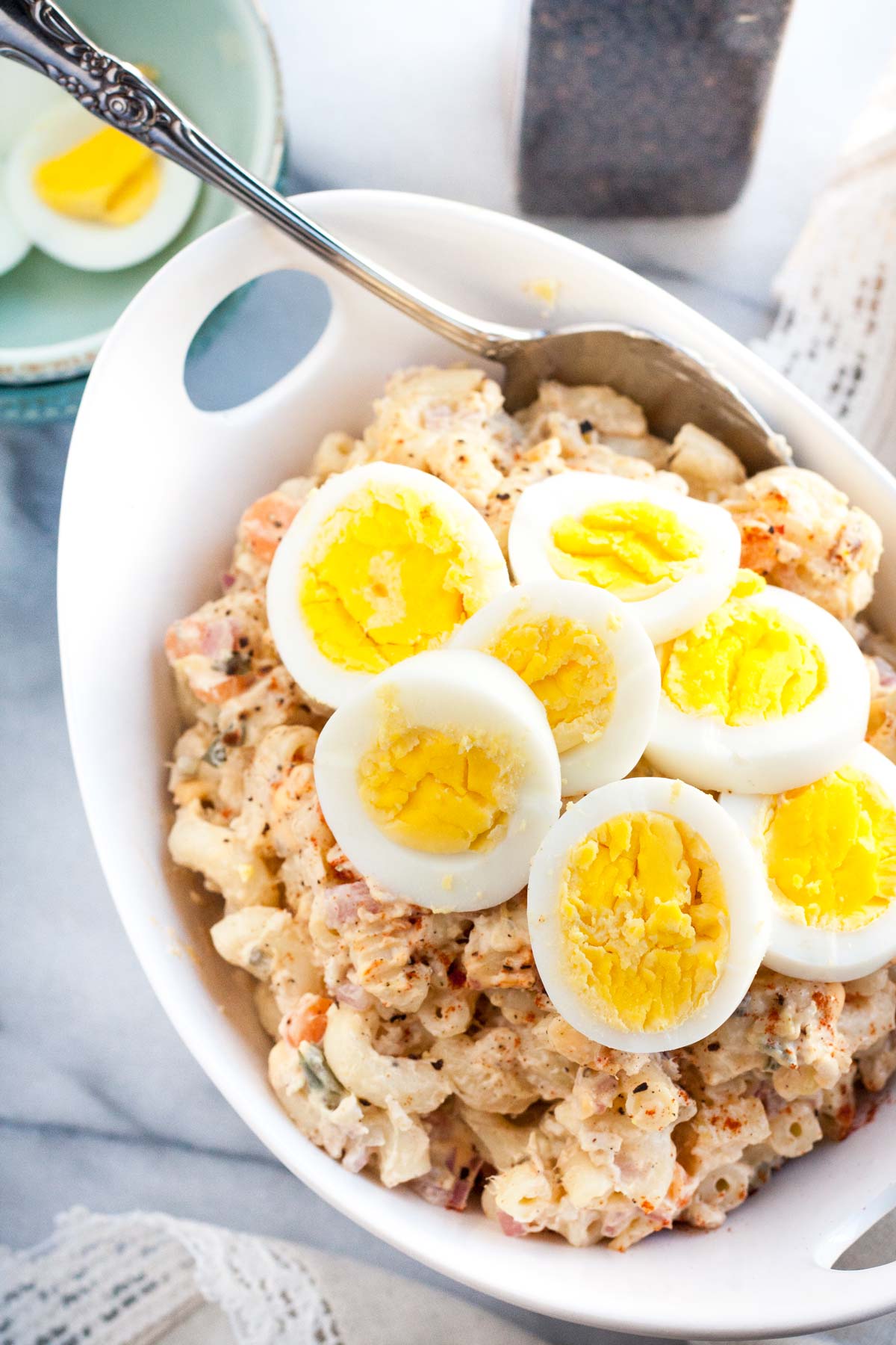 Quick and easy Homestyle Macaroni Salad - a perfect side dish for your summer barbeque. The combination of eggs, carrots, onions, relish, pineapple, and shredded chicken makes this salad extra tasty!