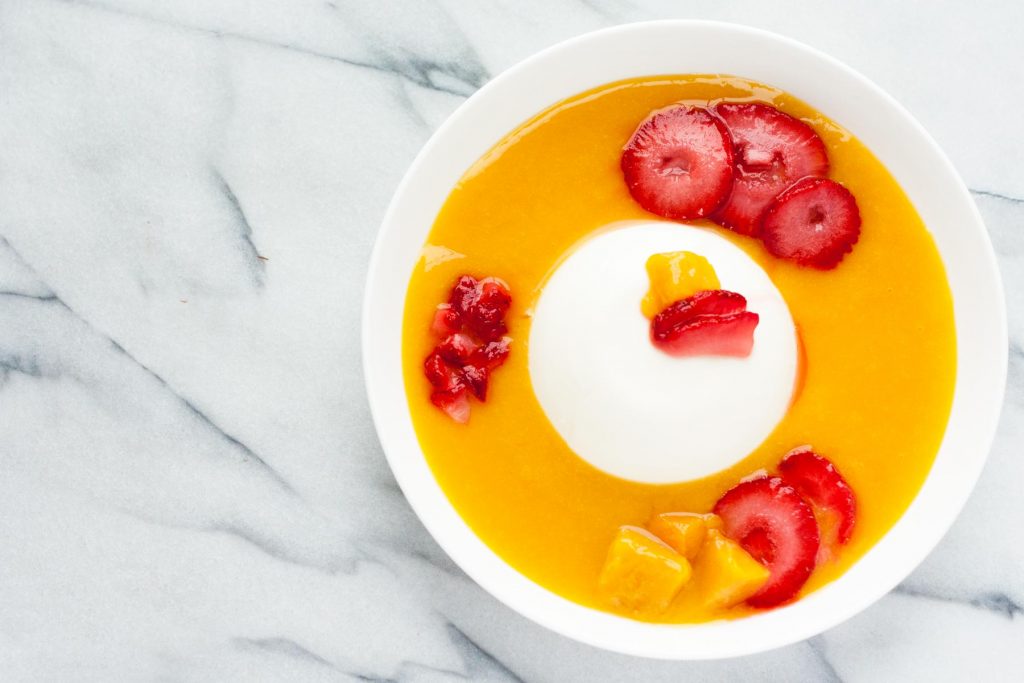 Perfect for a hot summer day – Cold and creamy Mango Summer Smoothie Bowl with Vanilla Panna Cotta! Top it with sliced strawberries and fresh mango chunks, and you’ll have fresh flavors of summer in a bowl! | www.SpoonfulOfButter.com