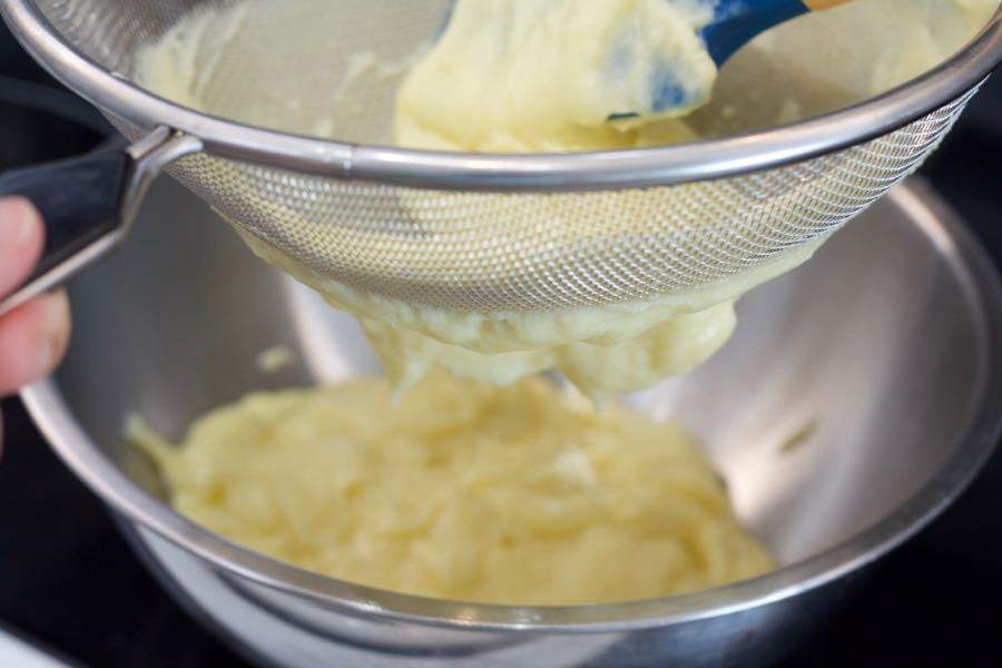 straining the pastry cream to remove lumps