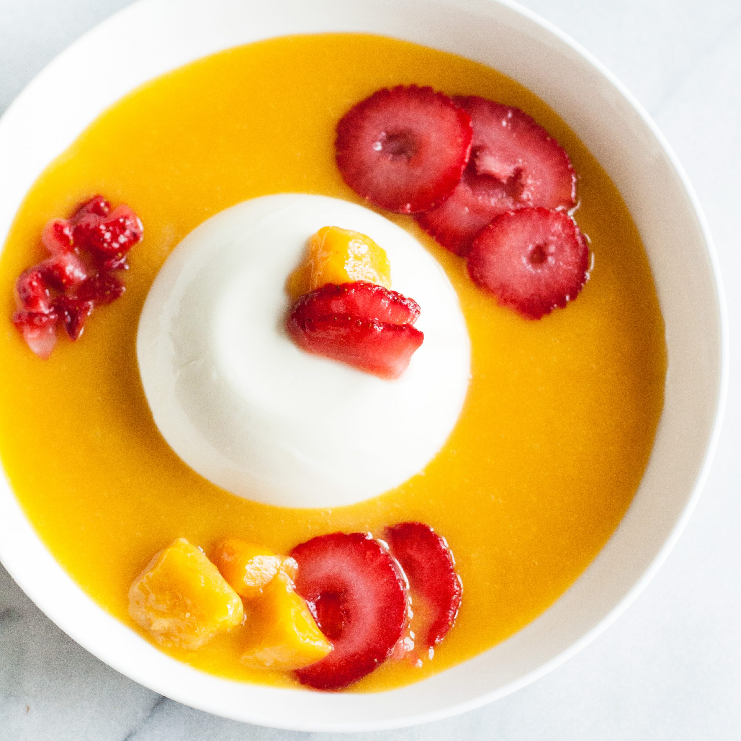 Perfect for a hot summer day – Cold and creamy Mango Summer Smoothie Bowl with Vanilla Panna Cotta! Top it with sliced strawberries and fresh mango chunks, and you’ll have fresh flavors of summer in a bowl! | www.SpoonfulOfButter.com