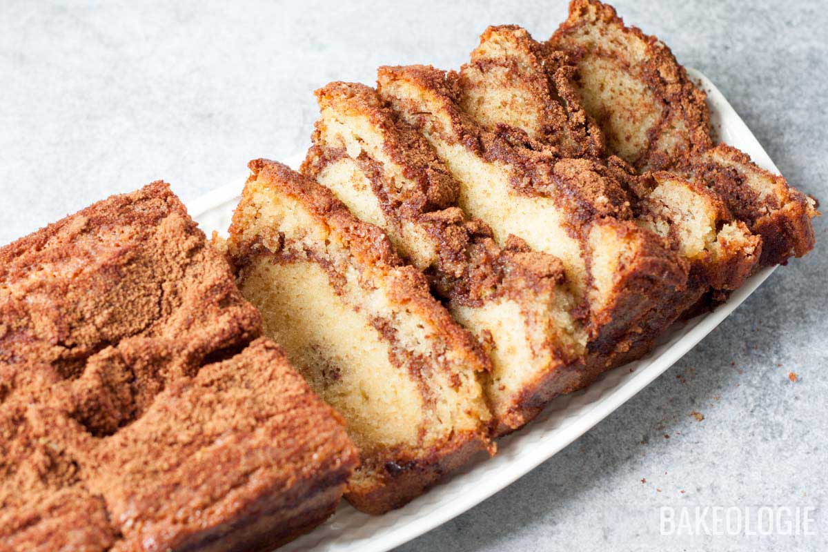 sliced cinnamon swirl loaf on a white rectangular plate