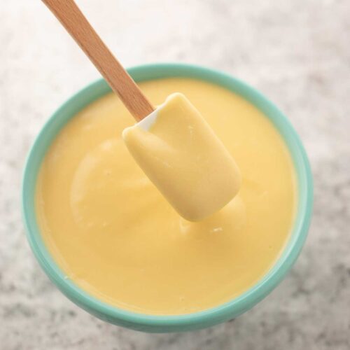 scooping pastry cream from a bowl