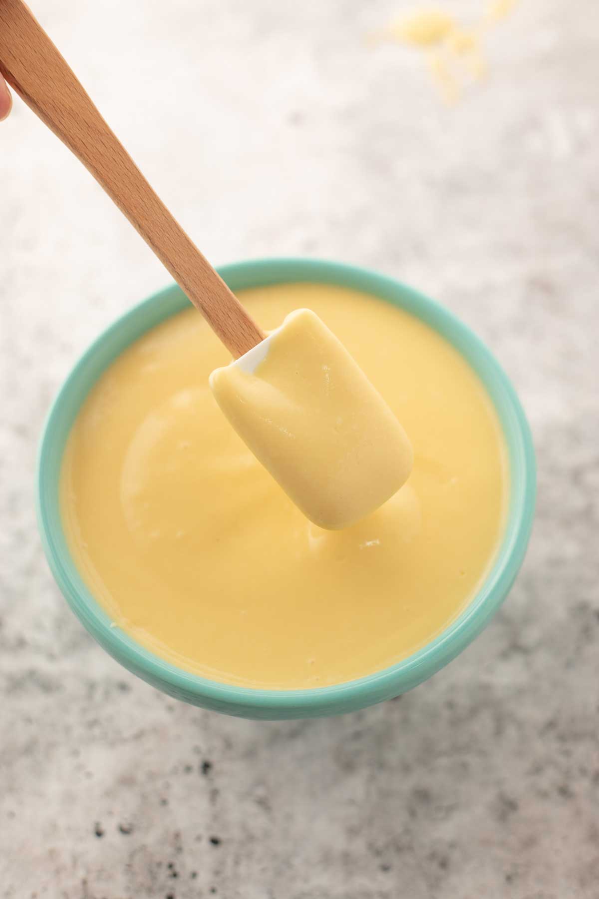 scooping pastry cream from a bowl