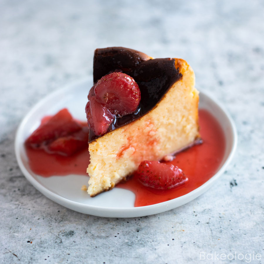 A slice of mini Basque cheesecake with strawberry compote topping