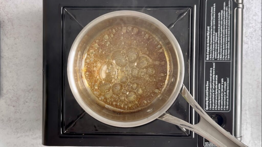 caramel that is starting to brown in a saucepan