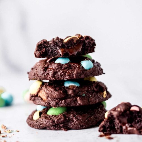 stack of chocolate mini egg cookies with melted dark chocolate oozing out