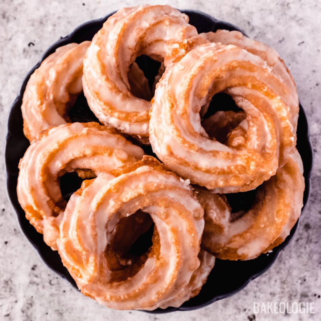 Chounuts or French Crullers on a round, blue plate