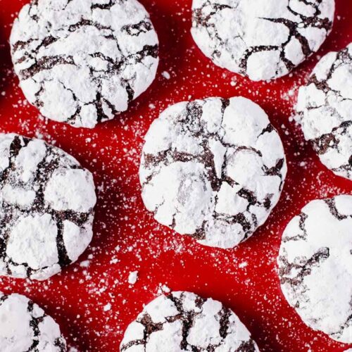 chocolate crinkle cookies on red baking tray