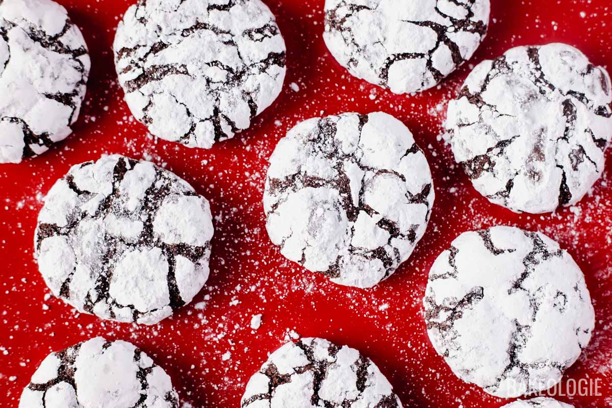 chocolate crinkle cookies on red baking tray