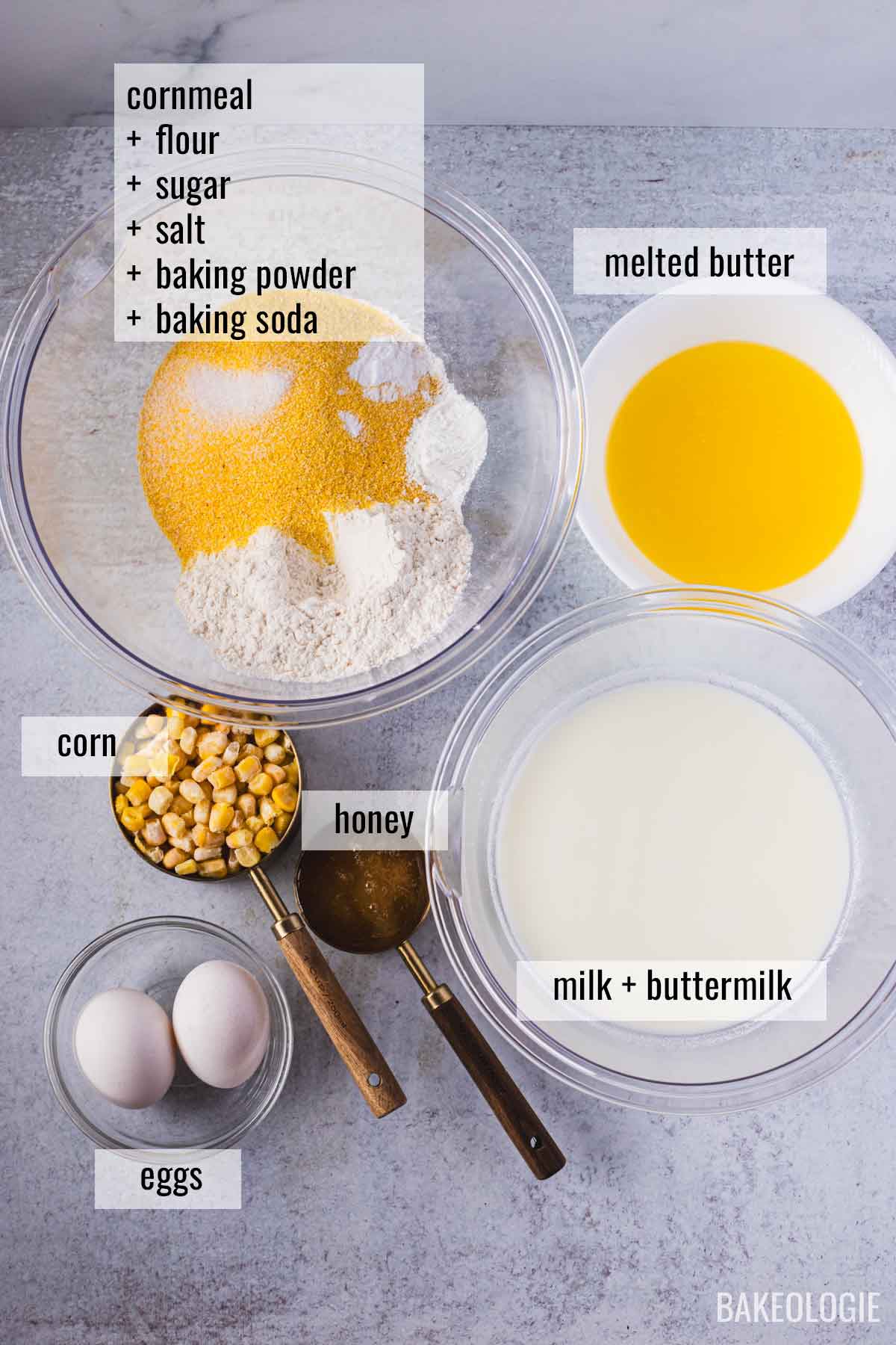 Ingredients for skillet cornbread recipe including cornmeal, flour, sugar, salt, baking powder, baking soda, eggs, milk, buttermilk, honey, corn, and melted butter.