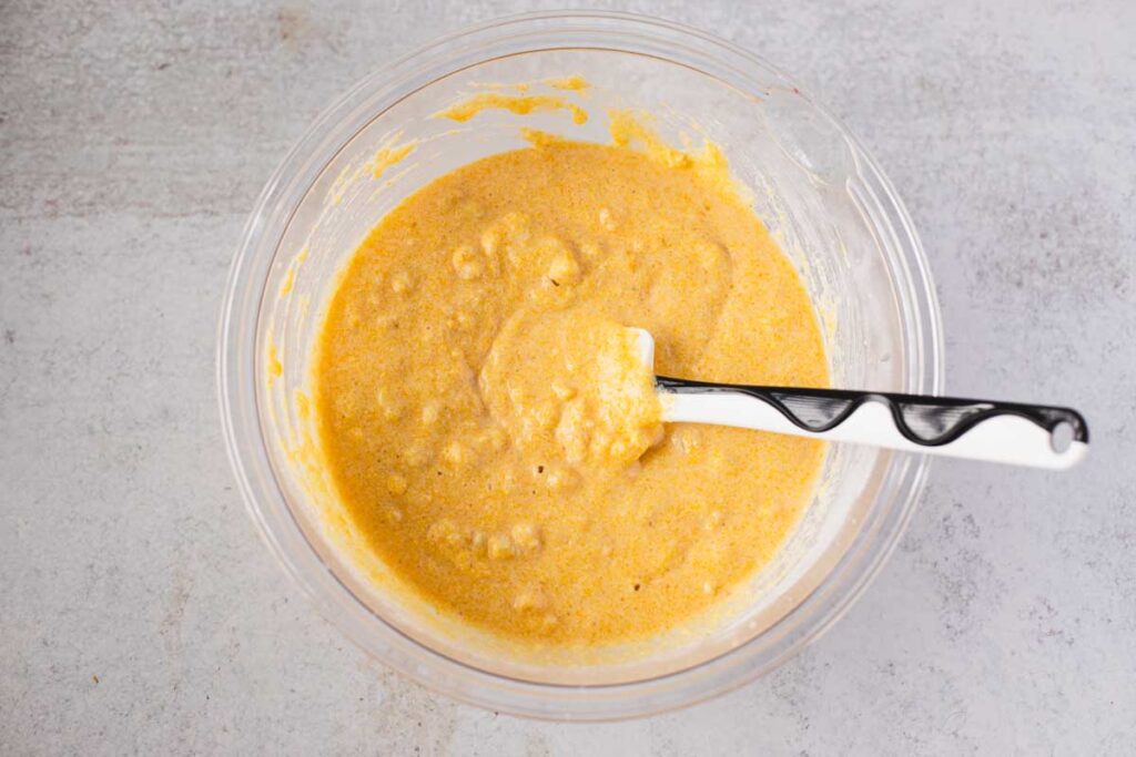 Cornbread batter mixed until just combined with corn kernels visible, ready to pour into skillet.