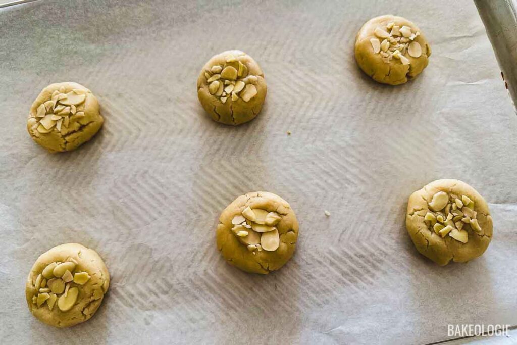 almond croissant cookies on a baking sheet