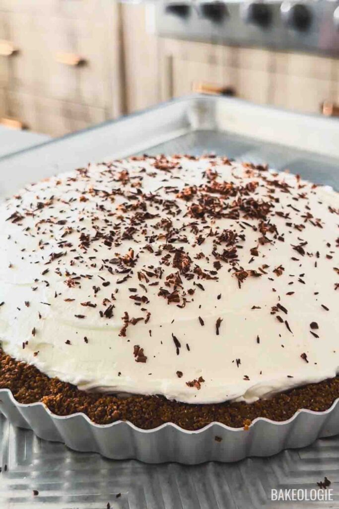 Finished Banoffee Pie topped with whipped cream and chocolate shavings