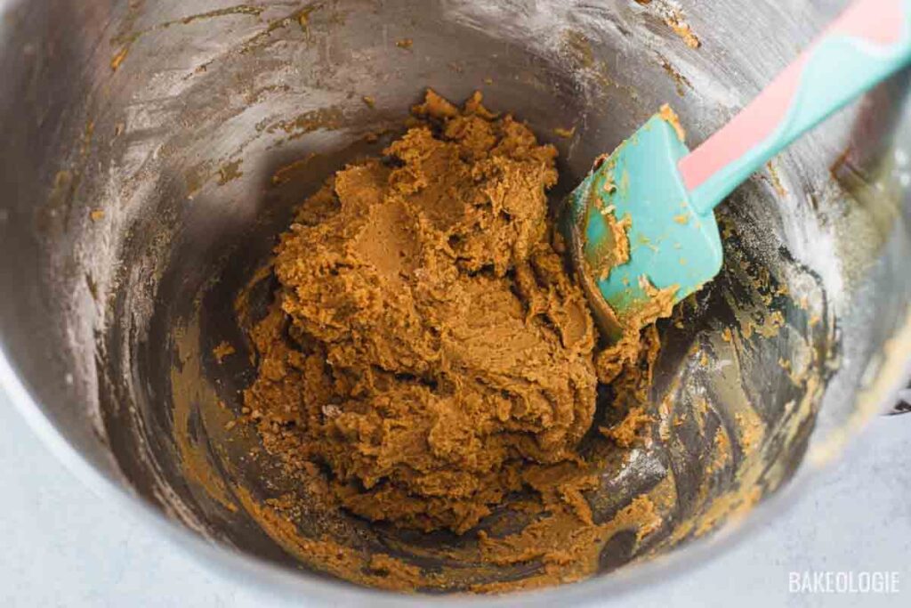 The coffee cookie dough after mixing in the dry ingredients, showing a soft, pipeable consistency in the mixing bowl.