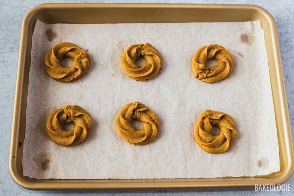 Baked coffee cookie swirls on a baking sheet.