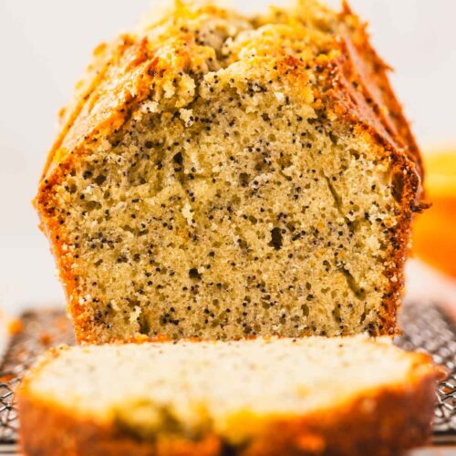 Close-up of orange poppyseed loaf cake showing moist, speckled crumb