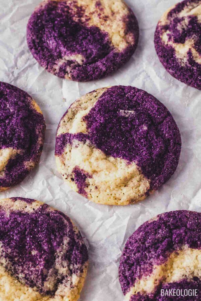 Marbled ube sugar cookies on parchment paper.