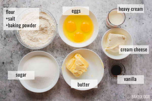 Ingredients for cream cheese pound cake measured and ready to use, including butter, cream cheese, eggs, flour, sugar, heavy cream, and vanilla.
