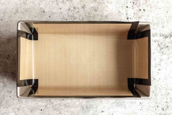Prepared 9x5-inch loaf pan lined with parchment paper for Funfetti Sour Cream Pound Cake.
