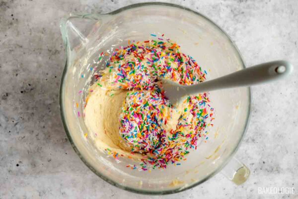Rainbow jimmies gently folded into Funfetti Sour Cream Pound Cake batter.