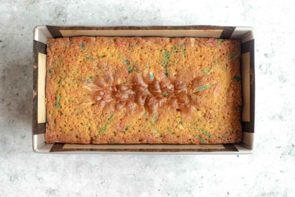 Freshly baked Funfetti Sour Cream Pound Cake with a golden top and classic center crack.