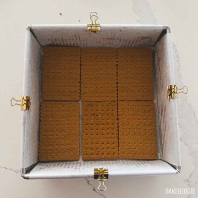 Honey graham crackers arranged in a single layer in an 8×8-inch pan